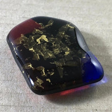 Load image into Gallery viewer, A dark red-blue-black fused-glass magnet with 24-carat gold leaf.