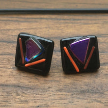 Load image into Gallery viewer, A pair of black fused-glass earrings with dichroic features.
