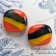 Load image into Gallery viewer, A pair of orange fused-glass cufflinks with yellow and mottled strips.
