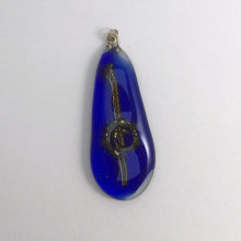 Load image into Gallery viewer, A blue fused-glass pendant with dichroic features and brass spiral.
