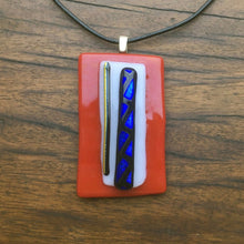 Load image into Gallery viewer, A red and white fused-glass pendant with dichroic features.
