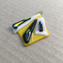 Load image into Gallery viewer, A yellow, white and black fused-glass pendant with dichroic features.
