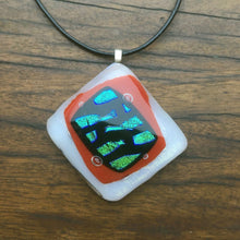 Load image into Gallery viewer, A red and white fused-glass pendant with dichroic wave features.
