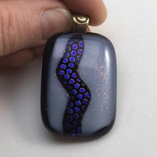Load image into Gallery viewer, A black and white fused-glass pendant with dichroic features.
