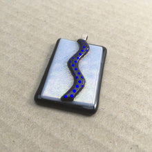 Load image into Gallery viewer, A black and white fused-glass pendant with a dichroic zig-zag feature.
