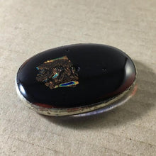 Load image into Gallery viewer, A dark red-black fused-glass magnet with dichroic features and tinned-copper wrap.
