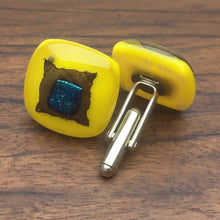 Load image into Gallery viewer, A pair of yellow fused-glass cufflinks with dichroic features.
